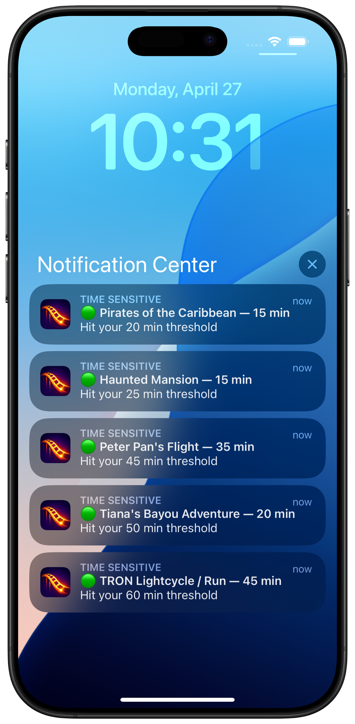 RideAlert push notifications stacked on the iPhone lock screen — Pirates of the Caribbean, Haunted Mansion, Peter Pan's Flight, Tiana's Bayou Adventure, and TRON Lightcycle all hitting their thresholds
